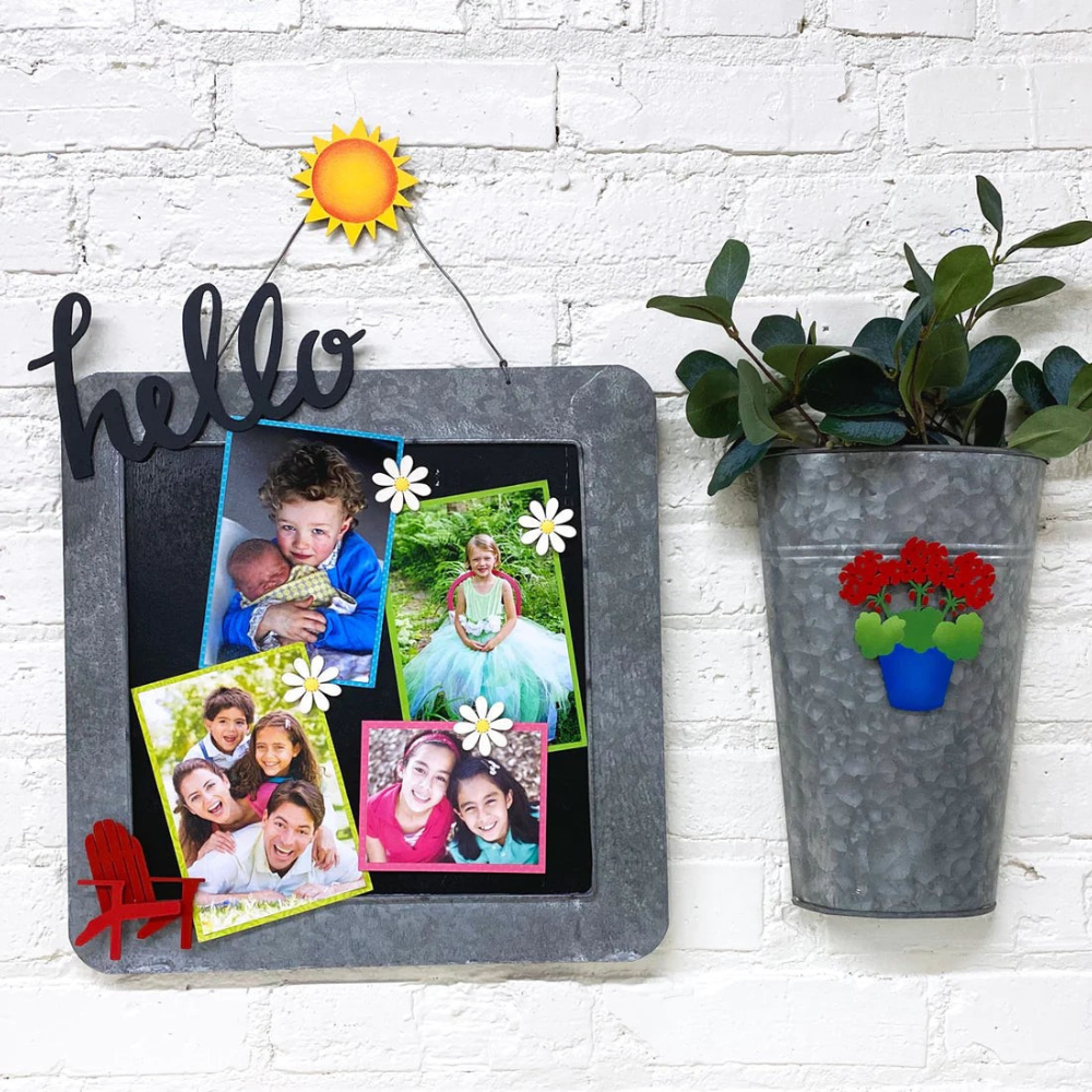 Black and silver memo board with decorative magnets and photos