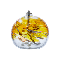 April Glass orb with yellow, amber and white coloured glass around the middle and horizontal webbing on a transparent background.